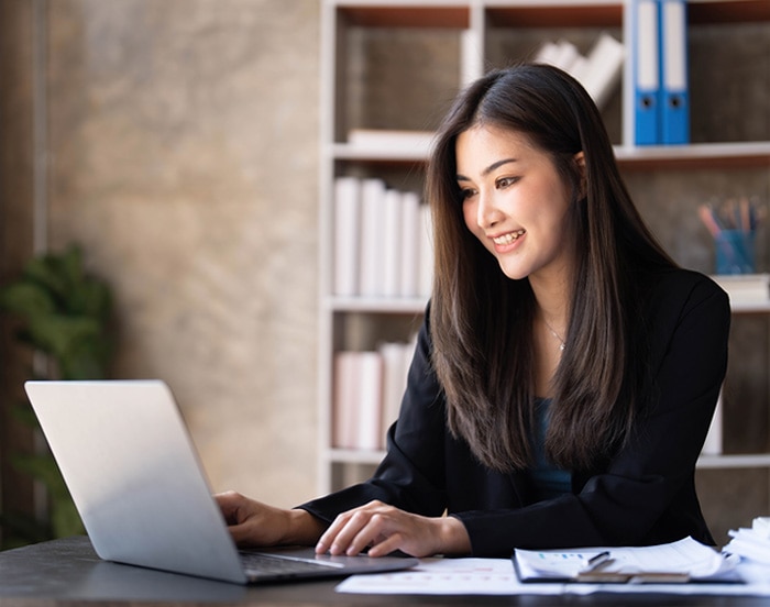 A person sitting at a desk with a laptop.