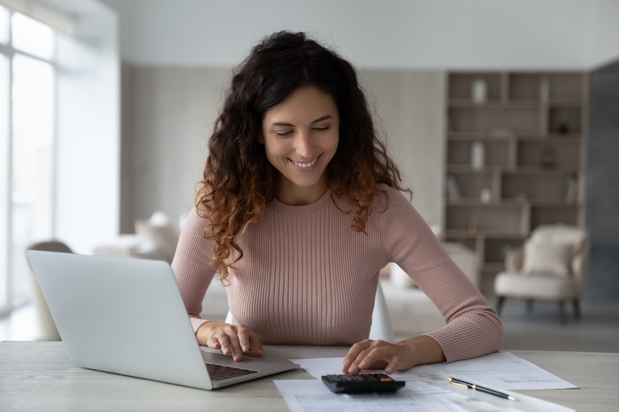 How to Create an Invoice template in Excel Woman creating an invoice for her small business in Excel