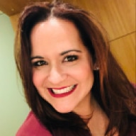 A person smiling and posing for a picture.