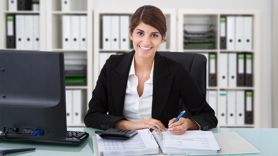 A person sitting at a desk with a laptop.