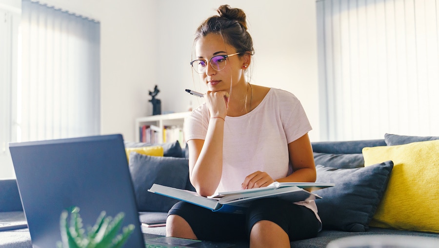 A person sitting at a desk with a laptop.