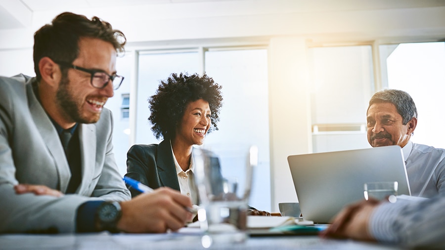 A person sitting at a desk with a laptop computer.