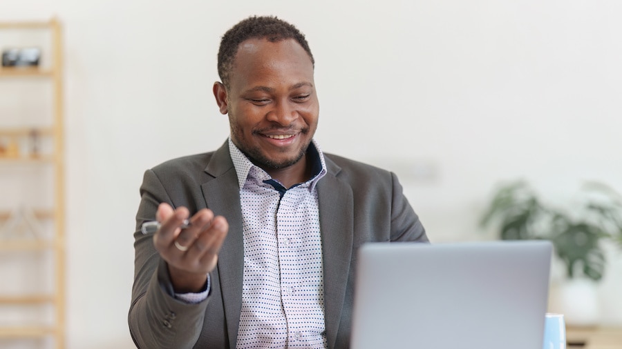 A person holding a laptop in his hands.