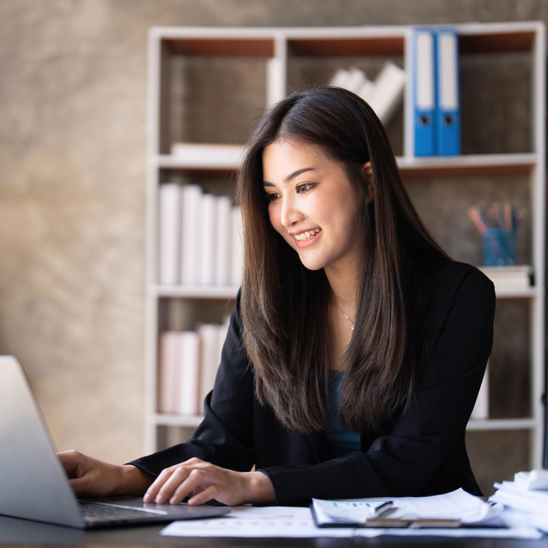 A person sitting at a desk with a laptop.