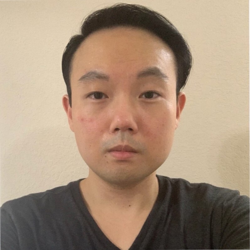 A person with a toothbrush in his mouth.