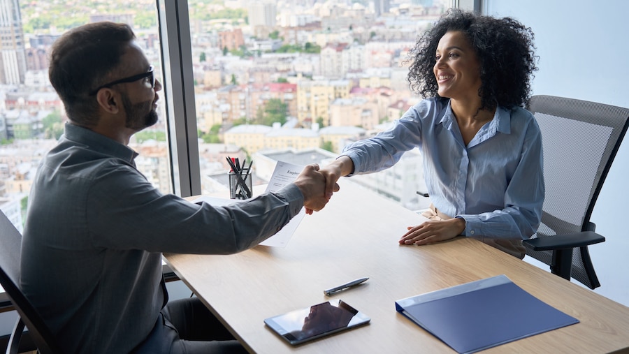 Firm owner shaking hands with a new hire.