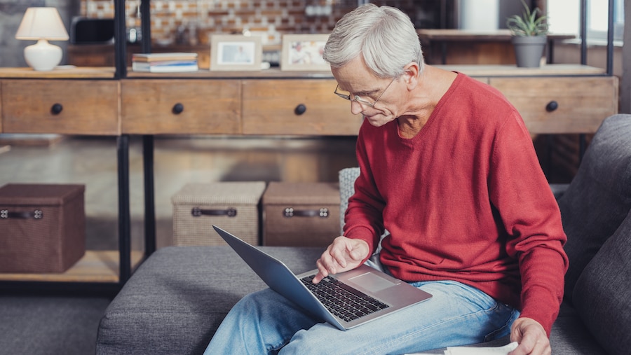 Man looking at his social security information on a laptop.