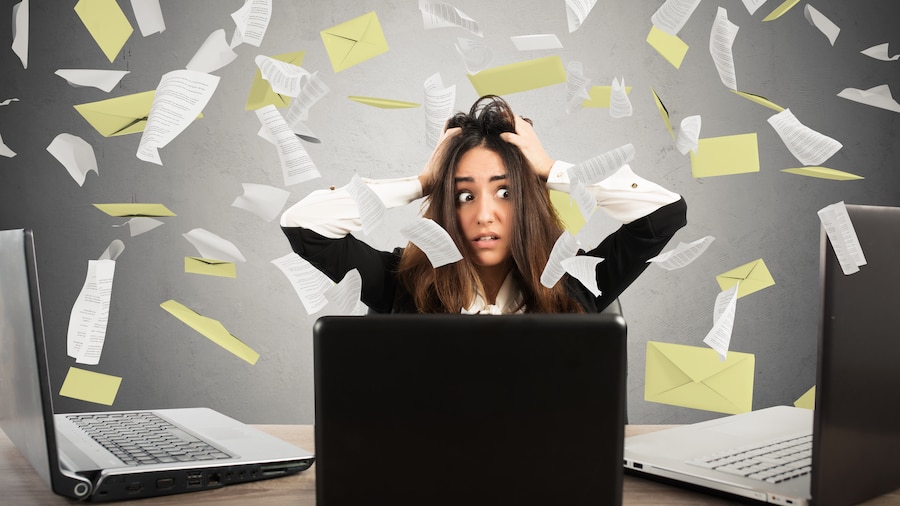 Businesswoman overwhelmed by emails.