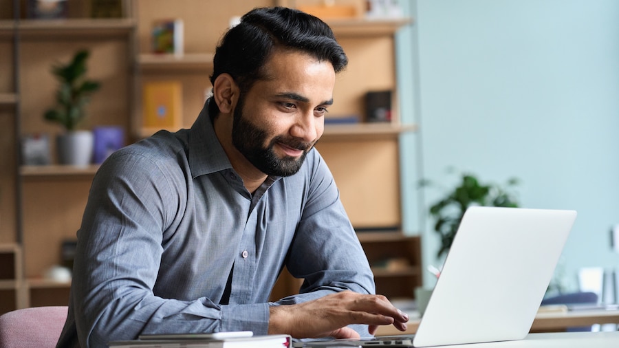 Accountant using QuickBooks Desktop on his laptop.