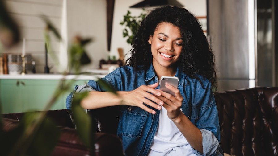 Female looking at an app on her phone.