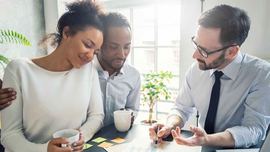 A financial advisor visiting with his clients.