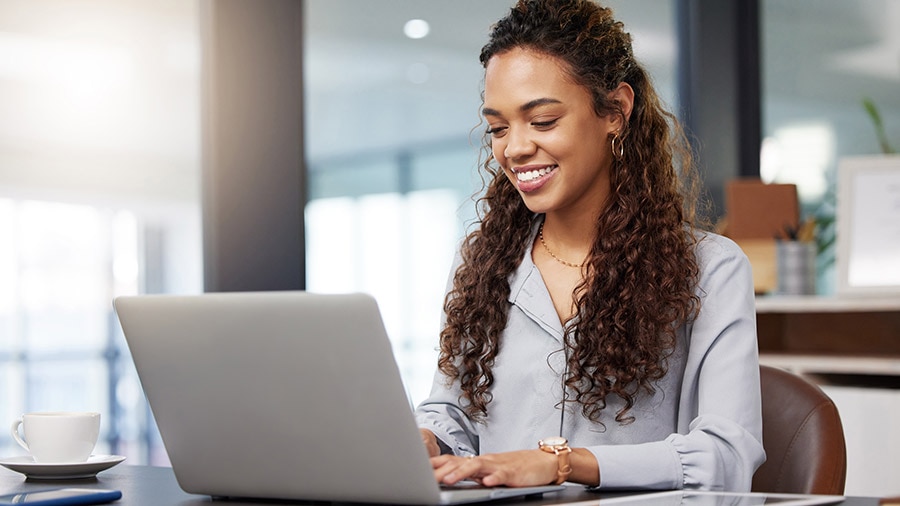 A person sitting at a desk with a laptop.