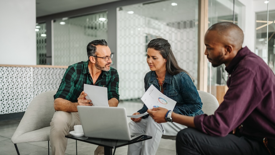 A financial advisor breaking down the financial healthy and strategy for two people at their business.