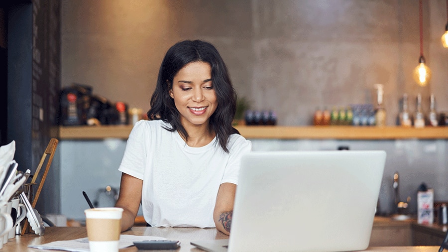 Female cafe manager barista calculating business finances