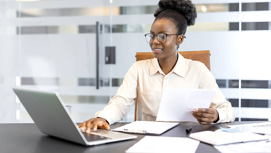 A person sitting at a desk with a laptop.