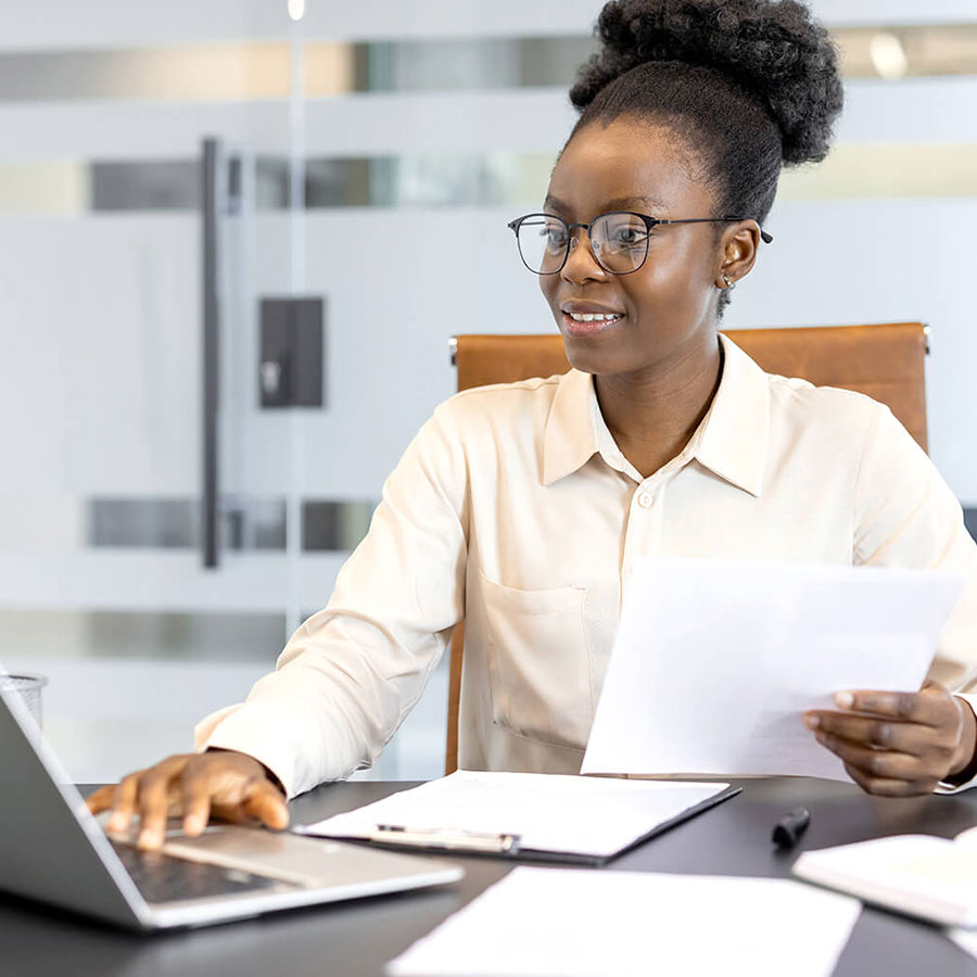 A person sitting at a desk with a laptop.