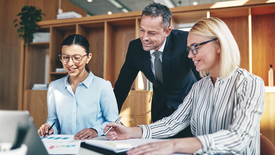 Accountants discussing new features in QuickBooks Online reports with their client.