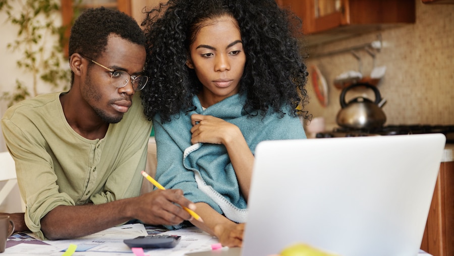 Two people looking at their bills online.