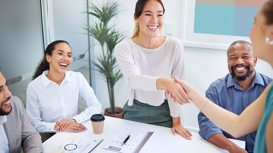 Five people are sitting around a table together.