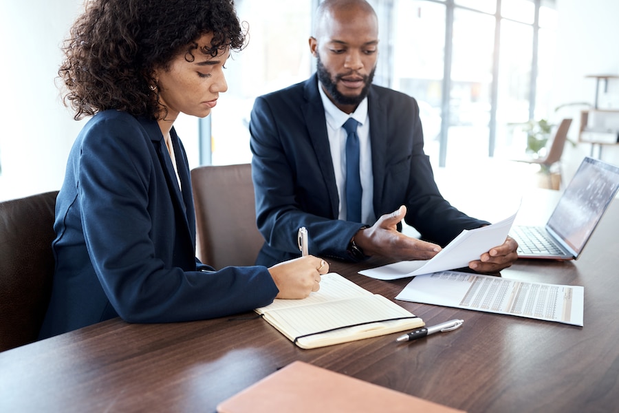 A financial advisor going over sales tax with a colleague.