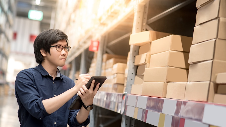 A man looking over inventory on his streamlined device.