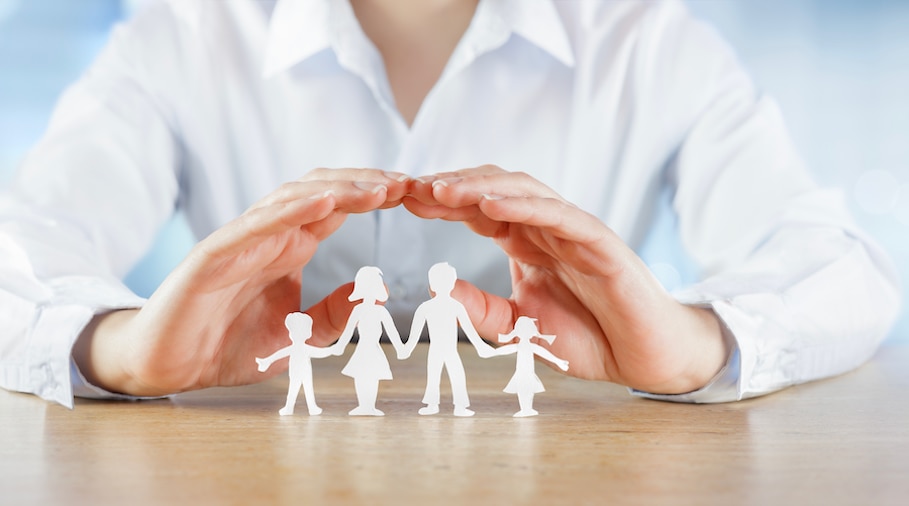 A family of three poses for a picture.