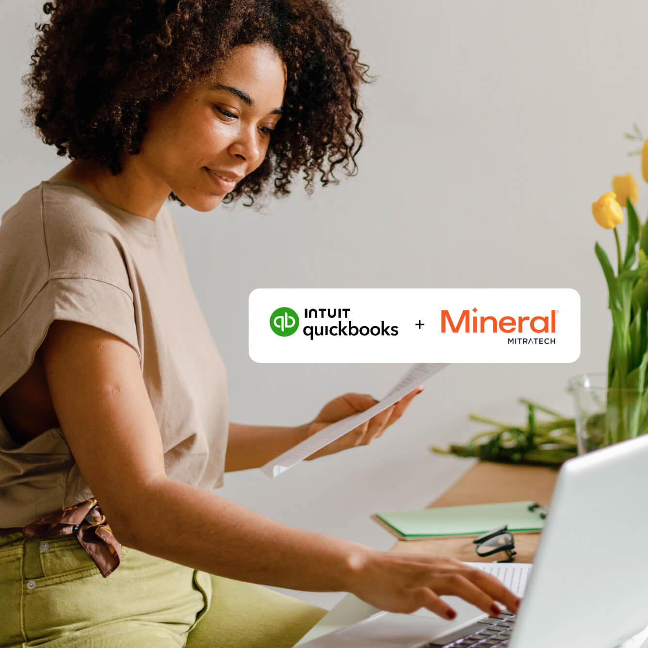 Woman working at desk with QuickBooks and Mineral